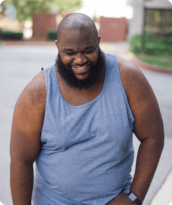Smiling man seated outdoors